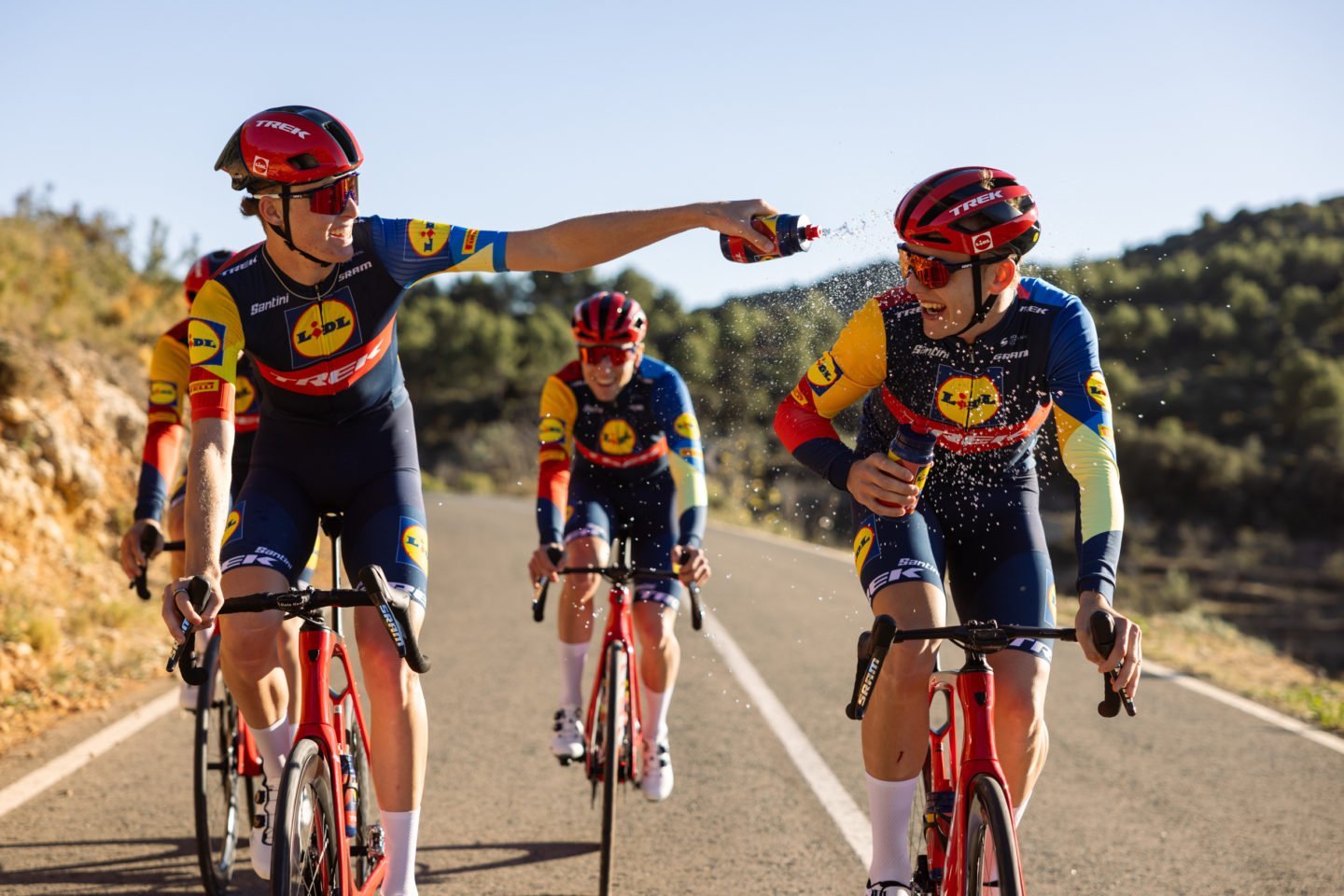 Cyclists riding Trek bikes on an open road